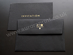 Black C6 envelope with gold foil printing.