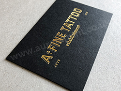 Matt black business cards with metallic gold foil print.