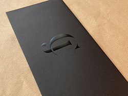 Black DL envelopes with gloss black foil print.