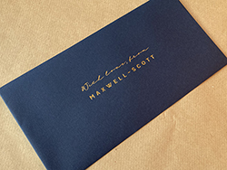 Dark satin gold foil printing on dark (imperial) blue DL sized colorplan envelopes.
