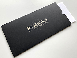 Die cut bespoke pocket envelopes with silver and clear foil printing.
