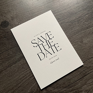 Gloss black and white uncoated save the date cards.
