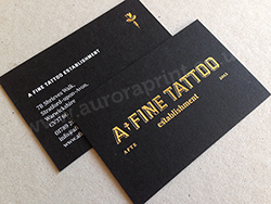 Gold foil logo and white text printed on a ebony business cards.