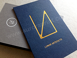 Gold foil printed business cards on a duplexed imperial blue and grey stock.