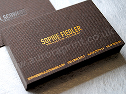 Bitter chocolate colorplan business cards with gravure embossing and gold foil printed text.