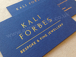 Gold foil printed text and logo on sapphire colorplan business cards.