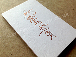 Rose gold foil printed business cards on coltskin embossed card