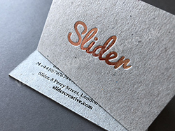 Rose gold business cards with black foil, for Slider Creative - printed on thick grey board.