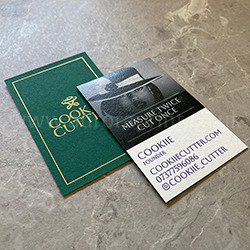 Duplexed forest green and natural ivory white business cards with metallic gold foil and colour print.