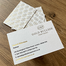 gold foil business cards on a pristine white uncoated card.