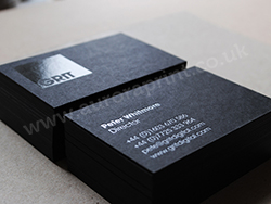 Matt black business cards with gloss black and white hot foil printing.