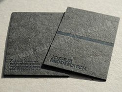 Matt black cairn business cards with matt black foil printing.
