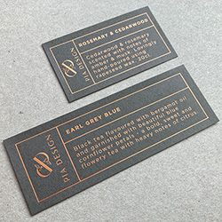 135gsm dark grey colorplan label material, printed with satin copper foil.